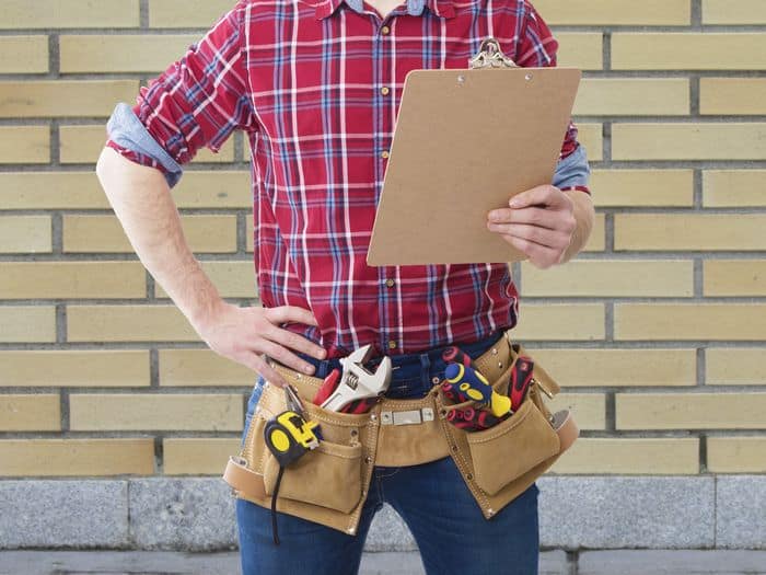 Construction worker holding clipboard for inspections