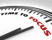 Clock hands pointing to the red word Focus - Focus Time - My Project Management Lessons