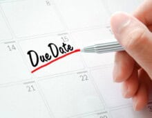 Hand writing the words "Due Date" on a calendar - Know why project due dates are set - myprojectlessons.com